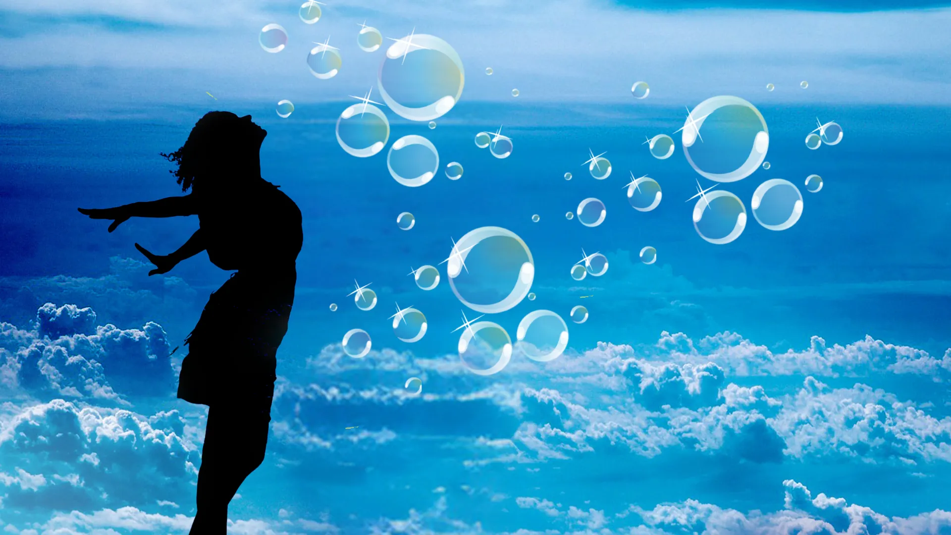 Silhouette of a woman with head thrown back and arms wide and bubbles floating all around her